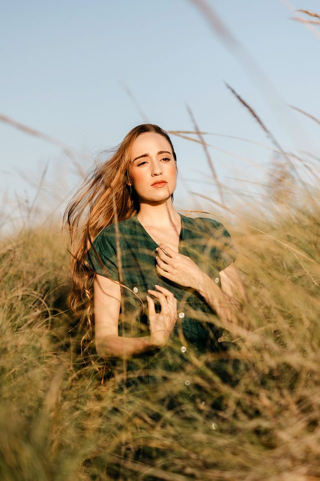 Woman in the meddle of a meadow