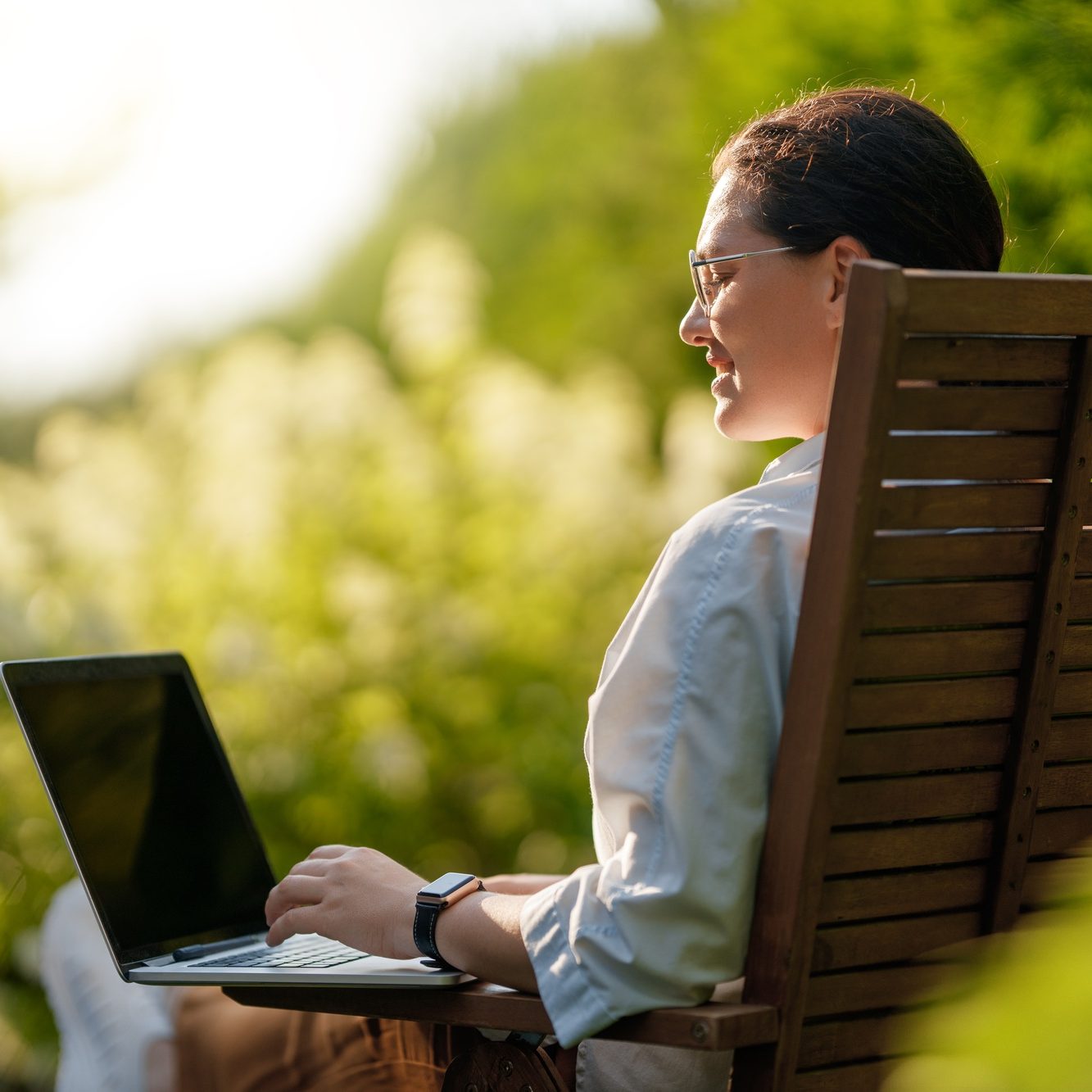 woman working on laptop in summer morning woman working on laptop in summer morning