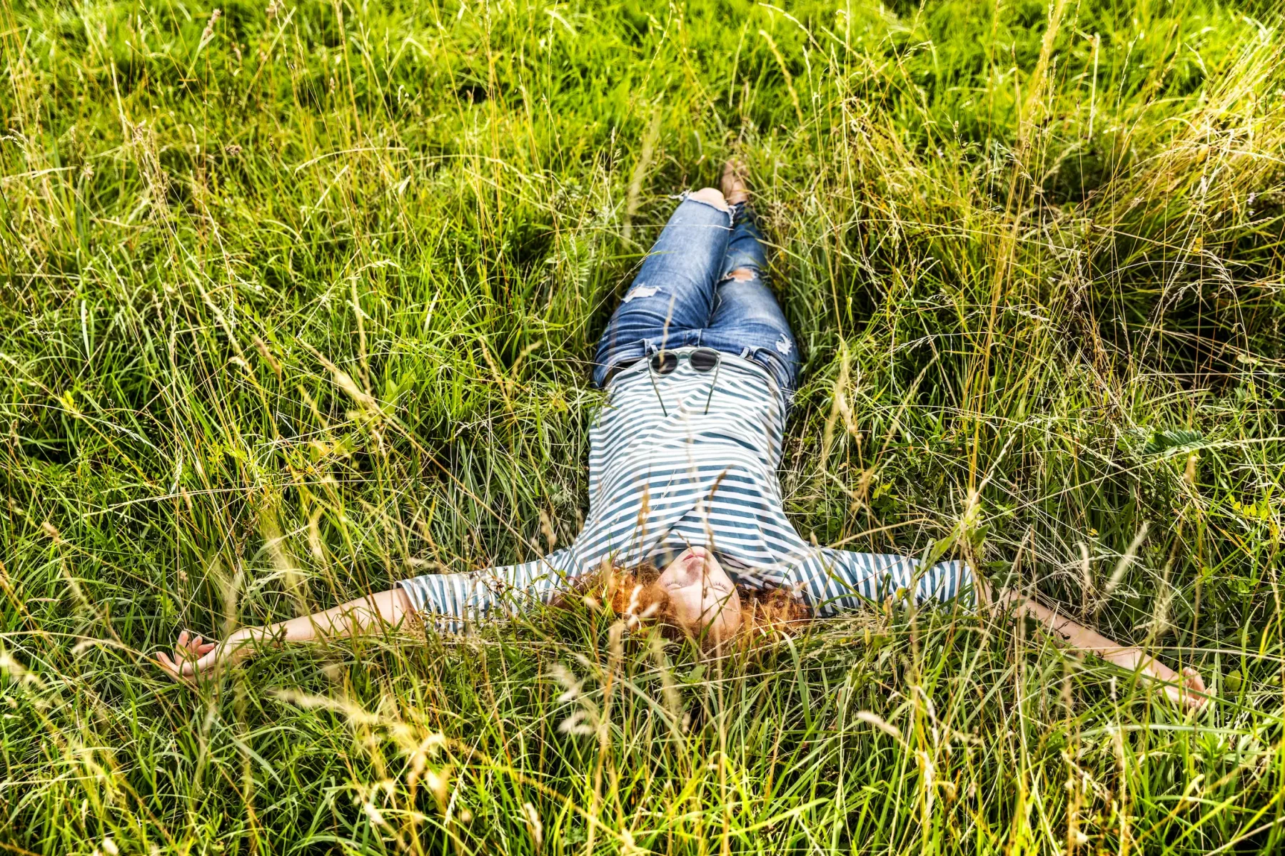 young-woman-relaxing-on-a-meadow-2024-09-17-04-53-26-utc